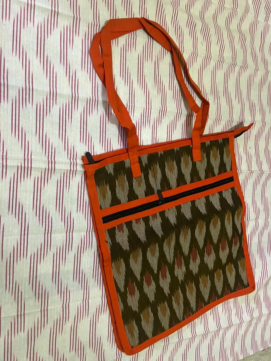 Product image: orange, olive, and black handbag