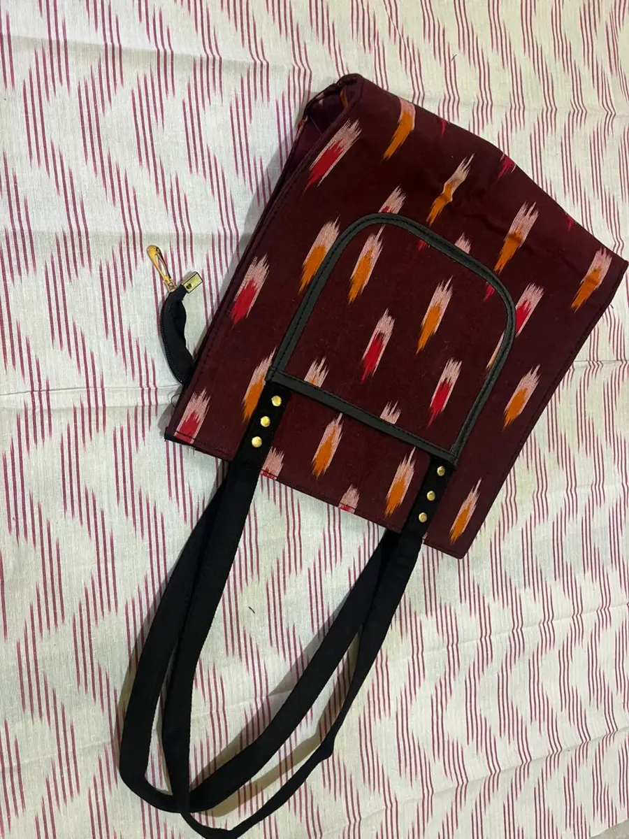 Product image: maroon and black handbag