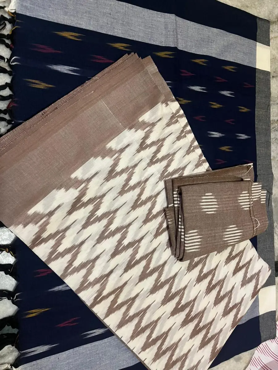 Product image: navy blue, cream, gray, and brown assorted textile pieces with small accessory