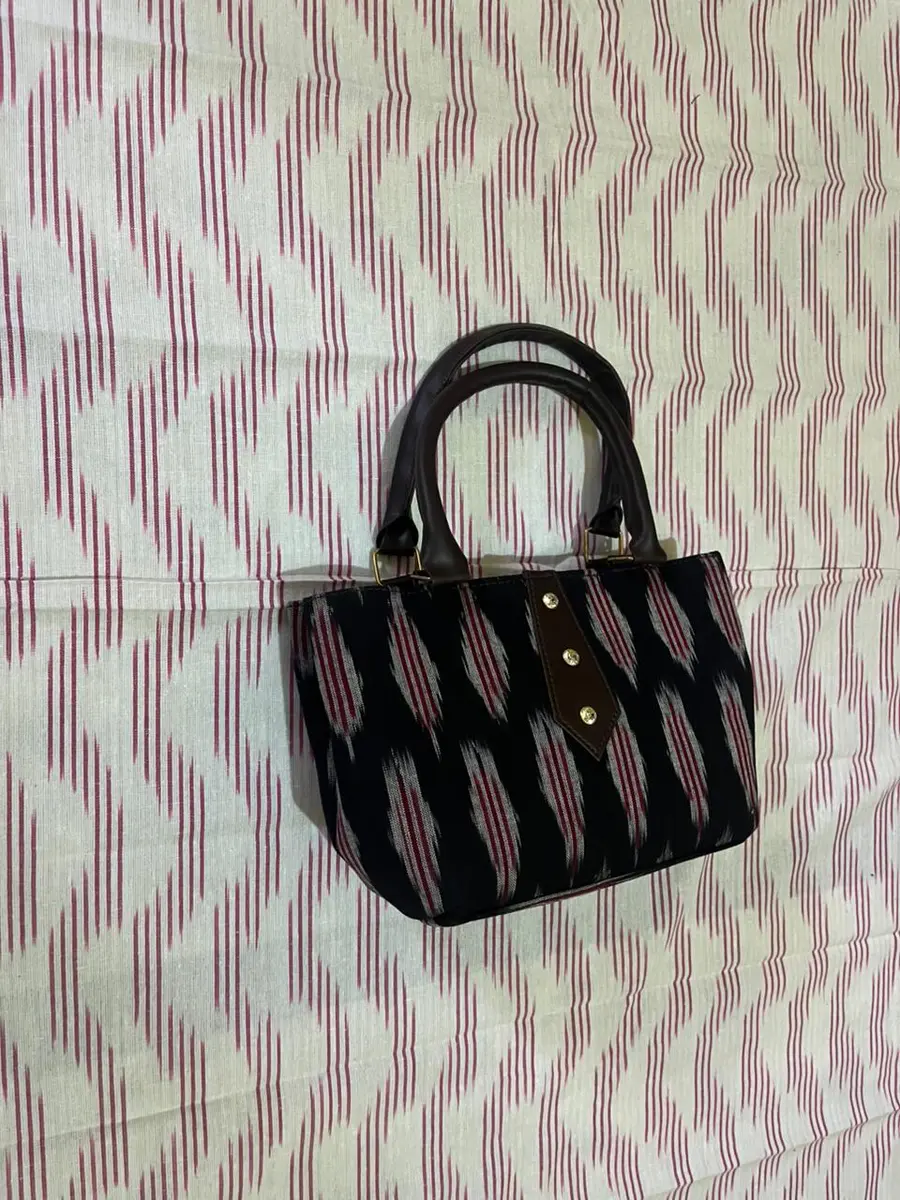 Product image: black and maroon handbag