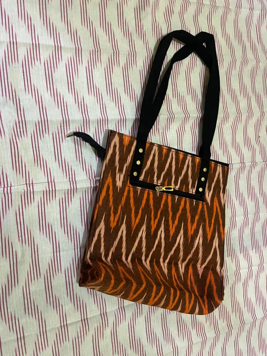 Product image: orange and black handbag