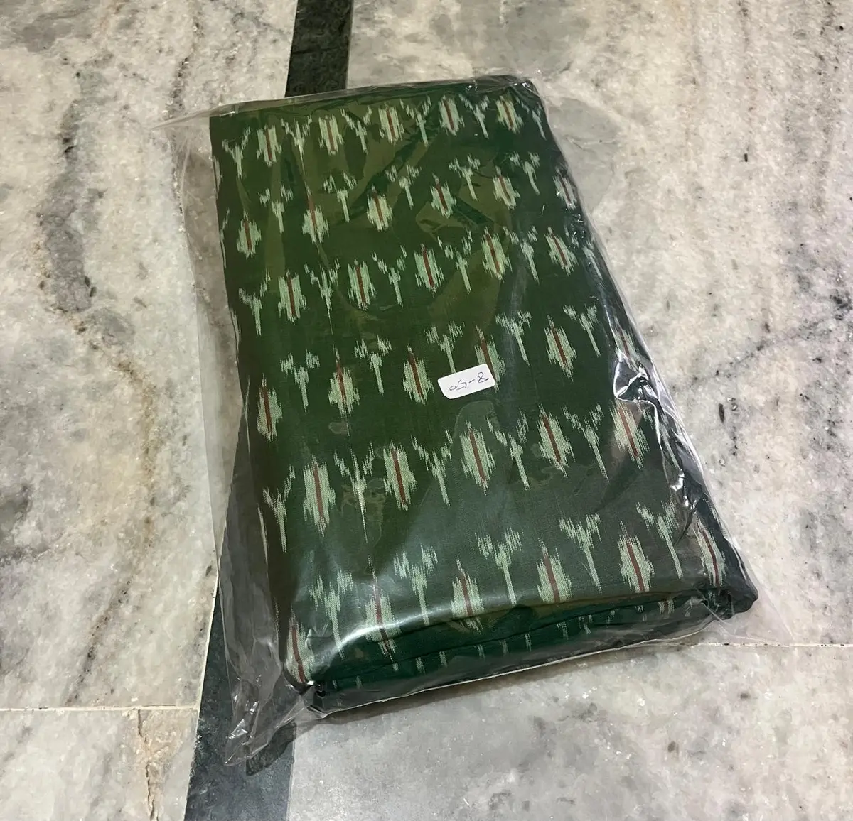 Product image: dark green folded packaged textile