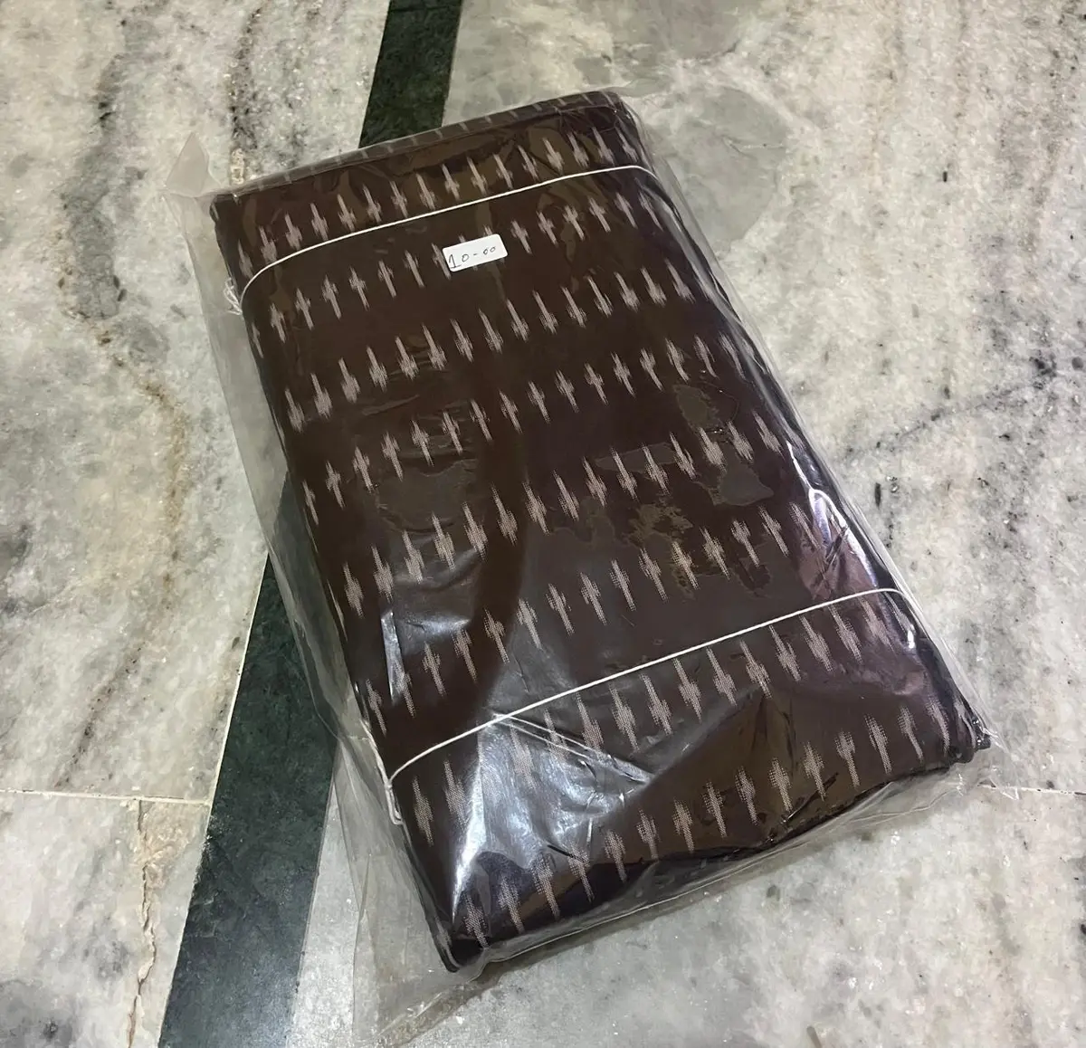 Product image: brown and cream folded packaged textile